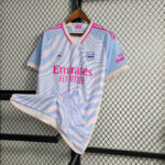 camiseta arsenal stella azul rosa frontal